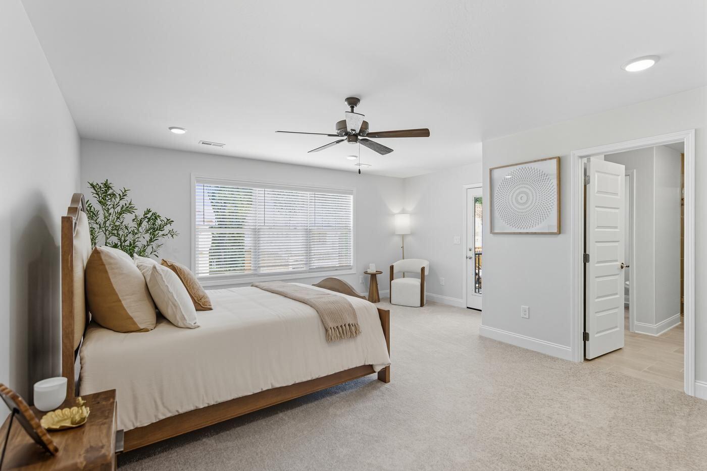 Poplar Creek guest bedroom with natural light and ceiling fan