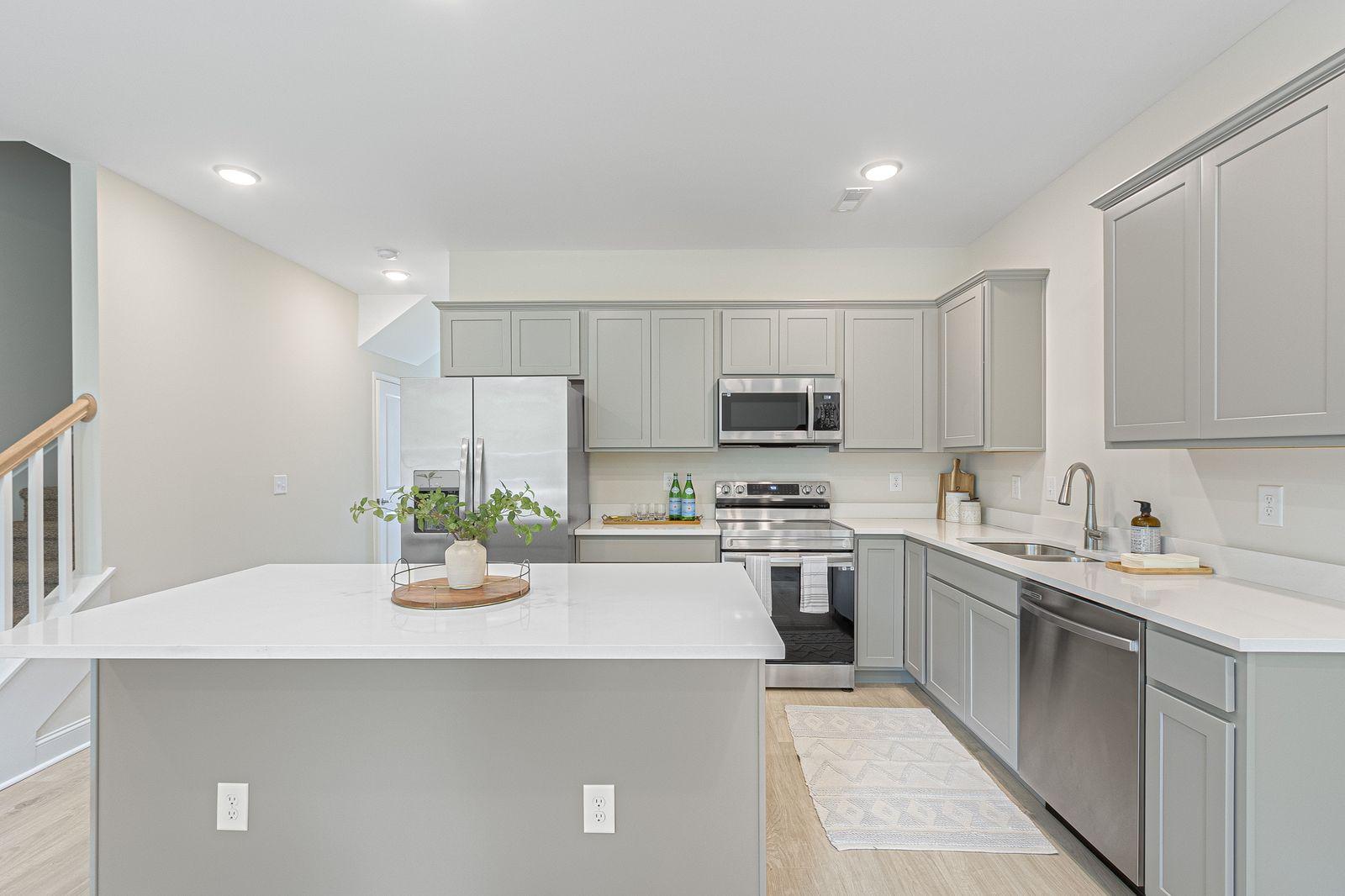 Snowmass modern kitchen with island, white cabinets, pendant lights, and premium finishes