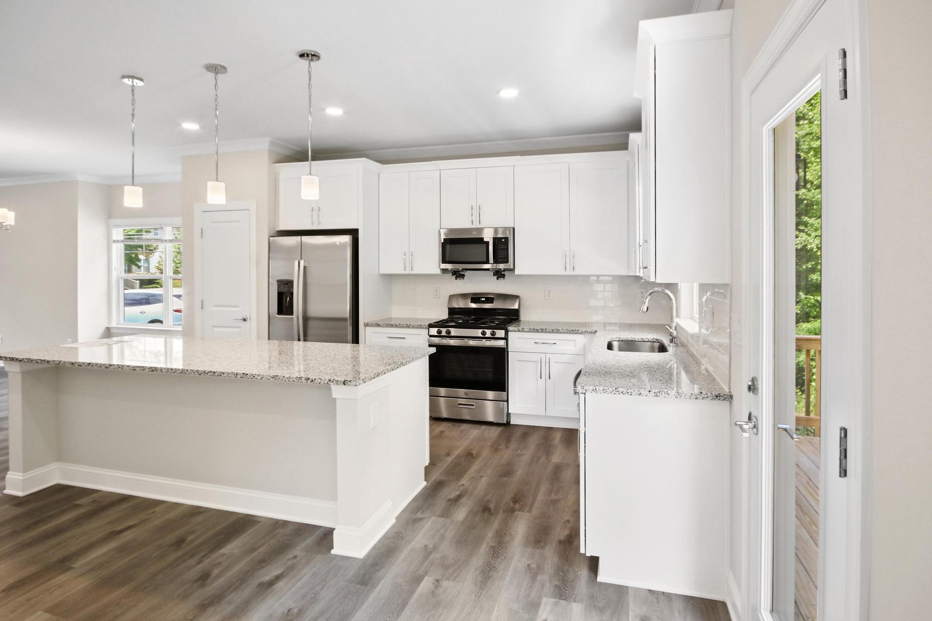 Dumphries Dr modern kitchen with island, white cabinets, pendant lights, and premium finishes
