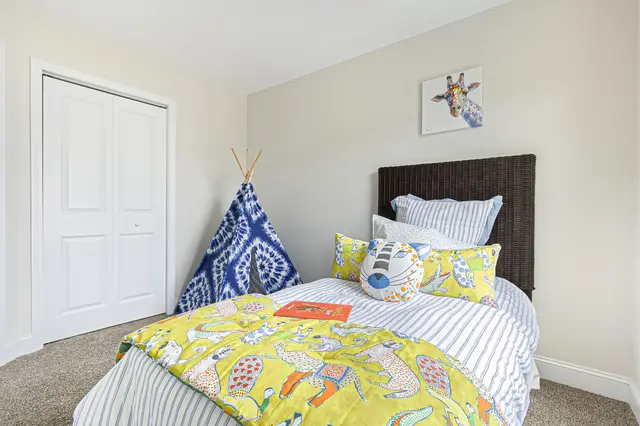 Snowmass guest bedroom with natural light and ceiling fan